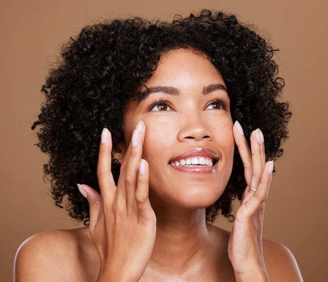 Woman resting her fingertips on her cheeks