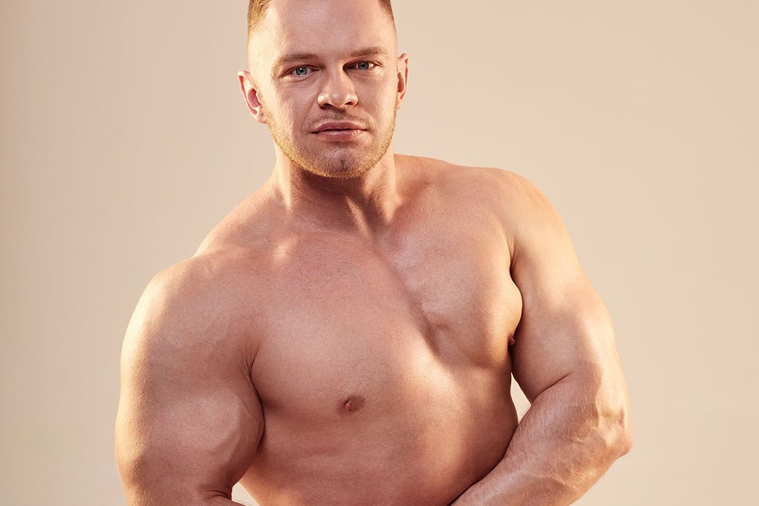 Fit man standing in a warm studio