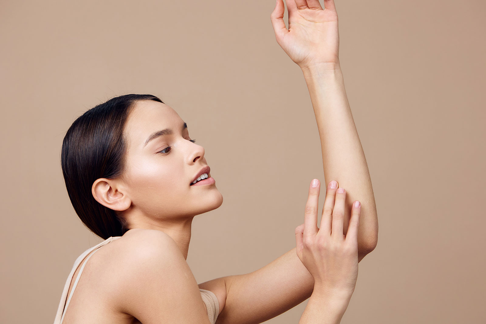 Woman touching the skin of her upper arm